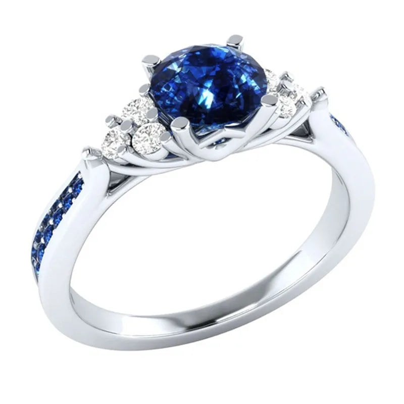 Silver S925 ring with a genuine blue sapphire gemstone, featuring intricate design and polished finish.