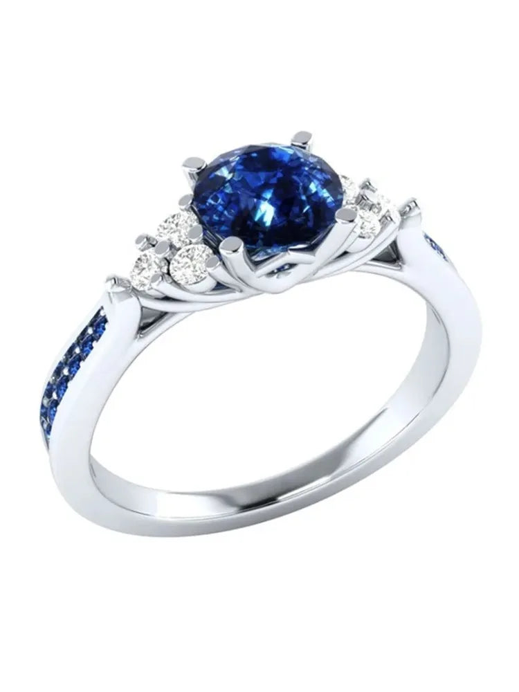 Silver S925 ring with a genuine blue sapphire gemstone, featuring intricate design details and a polished finish.