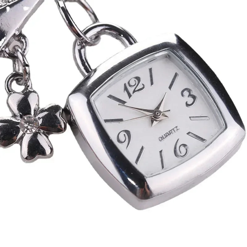Silver women's letter bracelet watch with chain band, stylish and elegant jewelry by Corporación Turística.