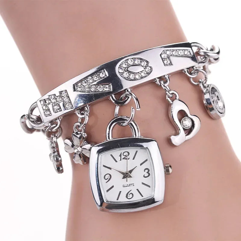 Silver women's letter bracelet watch with chain band from Corporación Turística, featuring a sleek and stylish design.