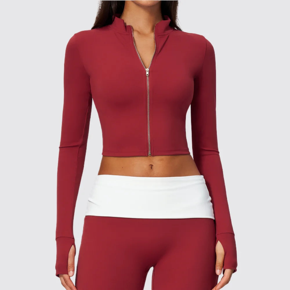 Pomegranate red women's long-sleeve sports T-shirt with zipper, by Corporación Turística, shown on a mannequin.
