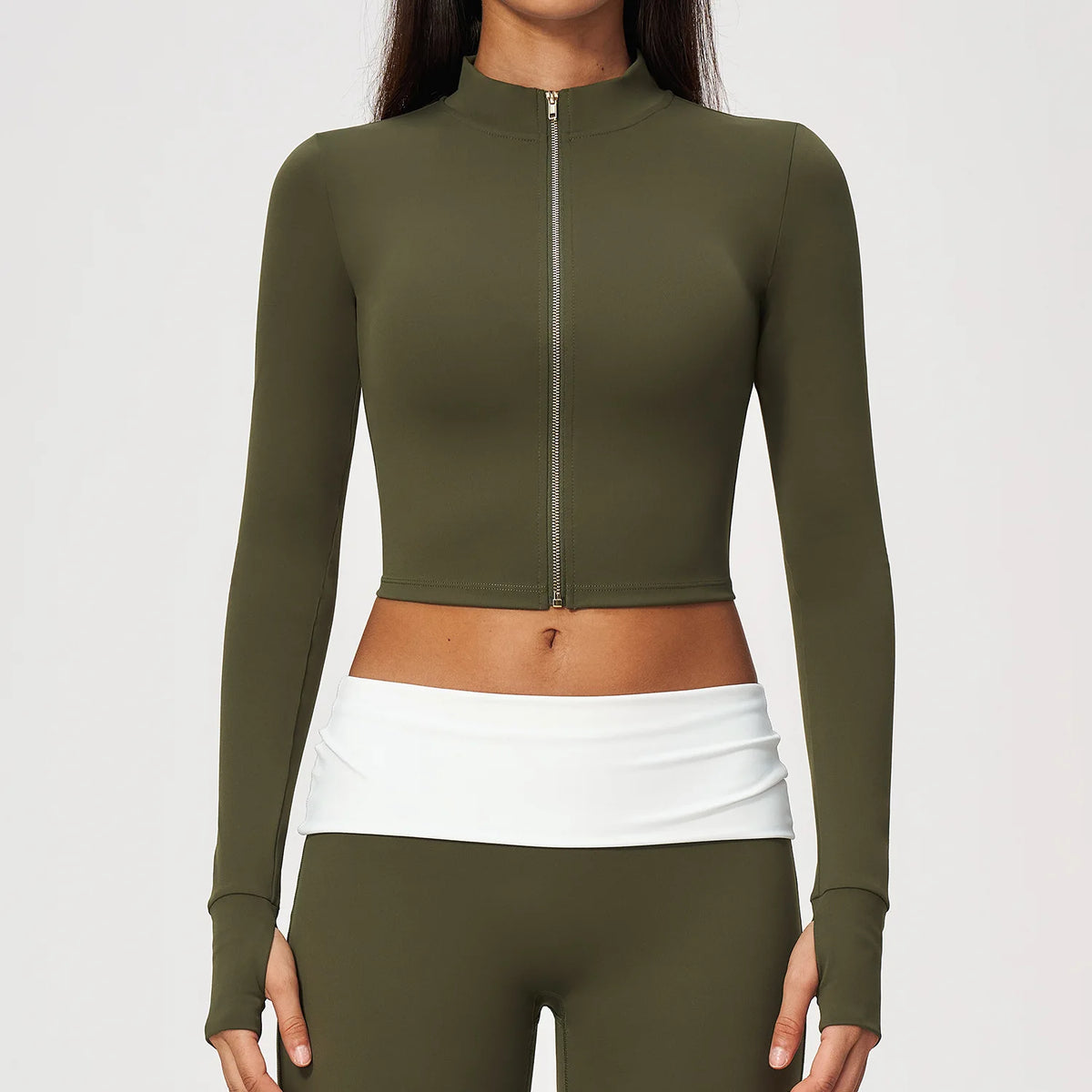 Pomegranate red women's long-sleeve sports T-shirt with zipper closure by Corporación Turística, shown on a mannequin.