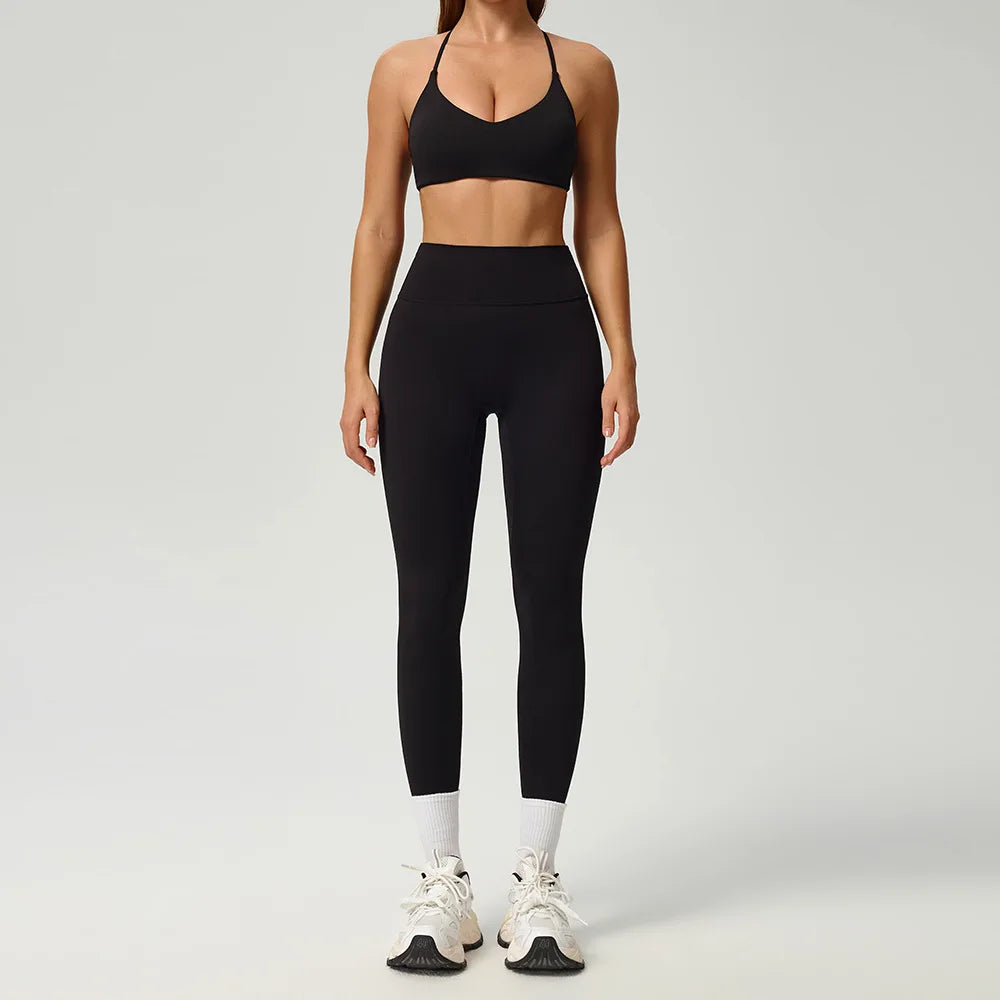 Black 2-piece women's sports set by Corporación Turística, includes a fitted top and athletic leggings for active wear.