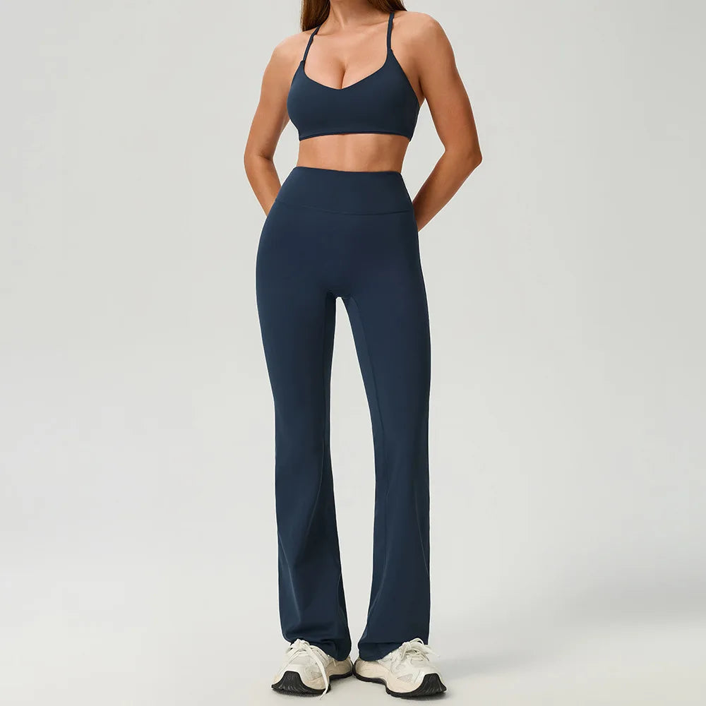 Black 2-piece women's sports set by Corporación Turística, includes a fitted athletic top and matching leggings.