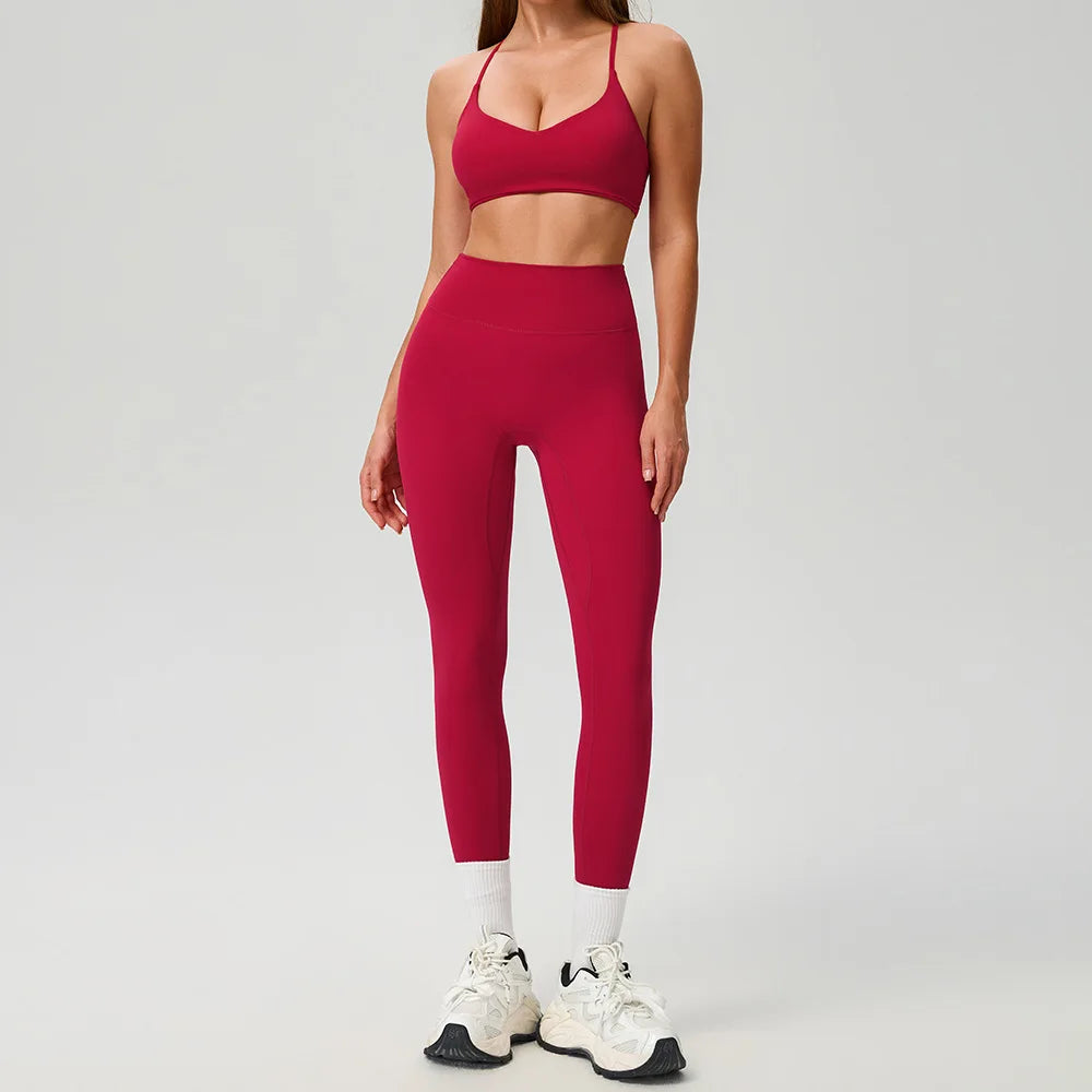 Black 2-piece women's sports set by Corporación Turística featuring a comfortable athletic top and matching pants.