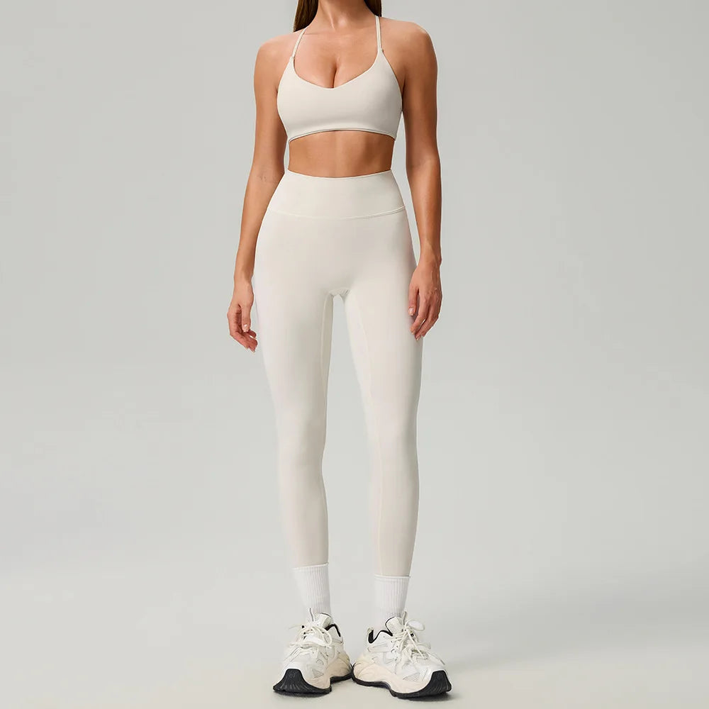 Black 2-piece women's sports set by Corporación Turística, includes a sports top and leggings for active wear.