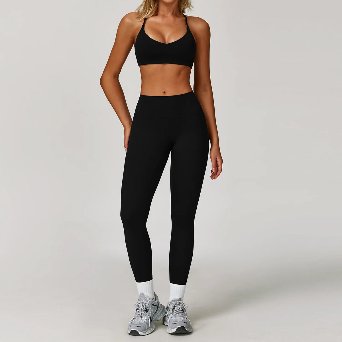 Black 2-piece yoga set for women by Corporación Turística, includes sports bra and leggings, made from comfortable athletic fabric.