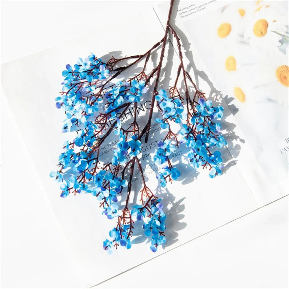 Two purple artificial Gypsophila flowers from Corporación Turística, realistic faux blossoms for home decor or floral arrangements.