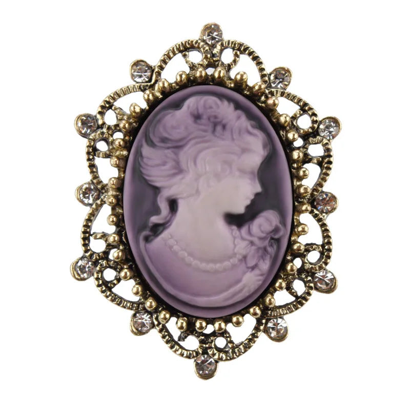 Purple vintage Queen cameo brooch with imitation diamonds, featuring intricate design and elegant jewelry craftsmanship.