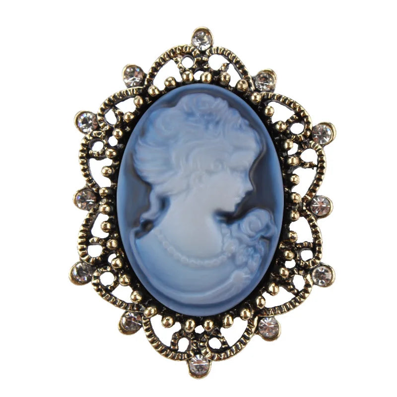 Imitation diamond cameo brooch featuring a queen design by Corporación Turística, purple color, vintage style accessory.