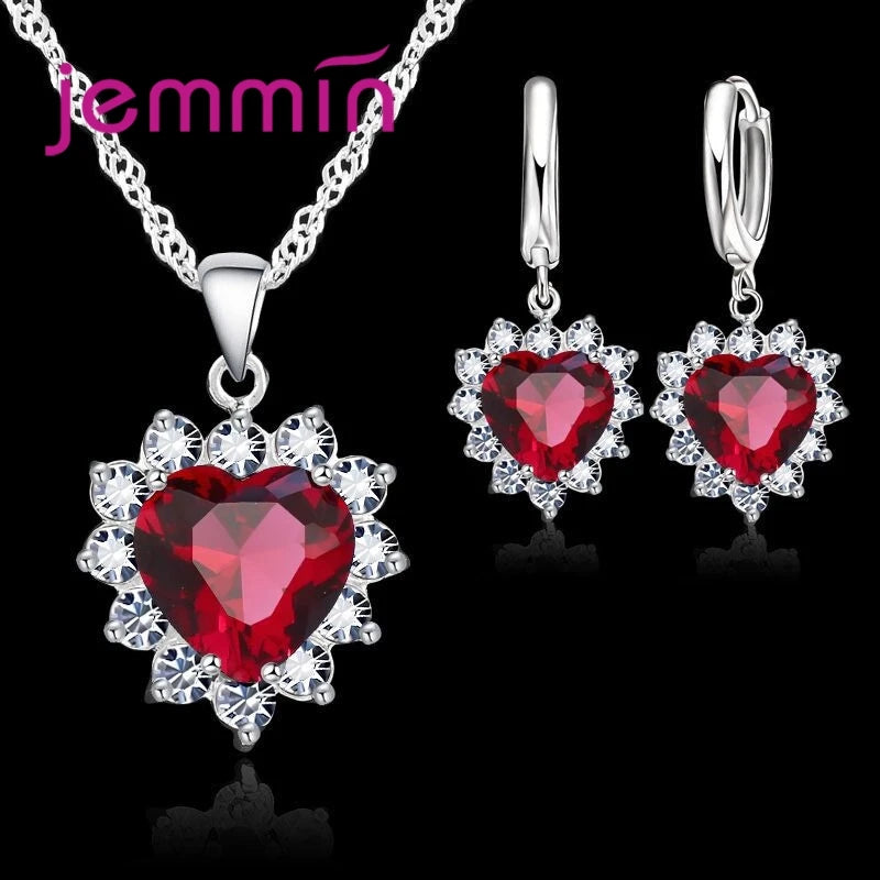 Purple jewelry gift set from Corporación Turística, featuring coordinated necklaces and earrings for anniversary celebrations.