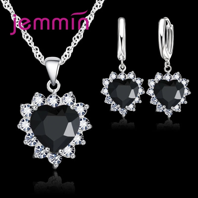 Purple jewelry gift set from Corporación Turística featuring matching necklace and earrings for anniversary celebrations.