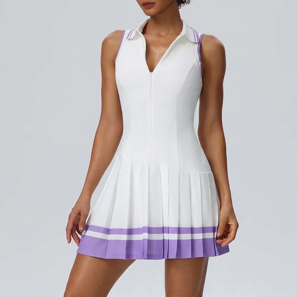 Purple one-piece tennis dress with fold-over collar from Corporación Turística, shown on a model.