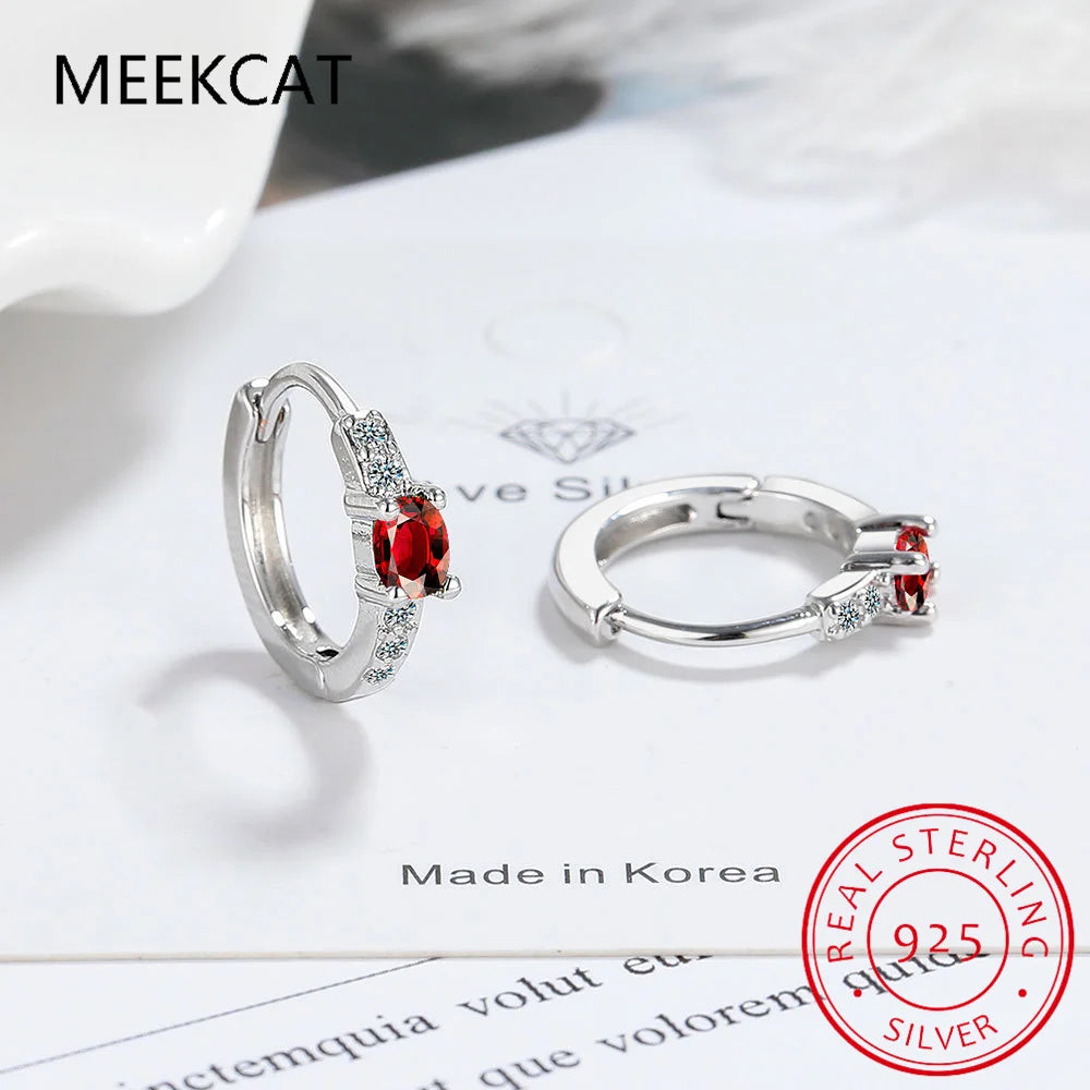 Silver 925 blue sapphire hoop earrings featuring oval-shaped gemstones, stylish and elegant jewelry by Corporación Turística.
