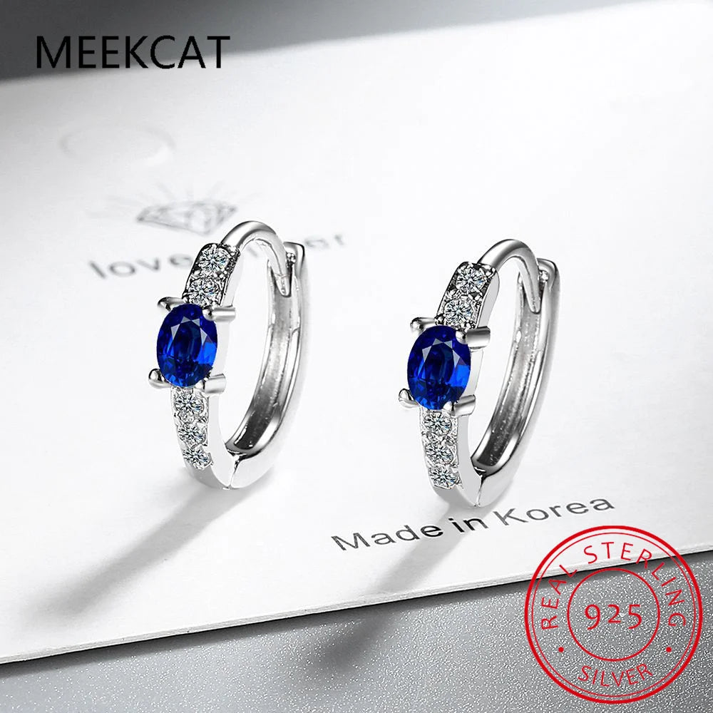 Sterling silver 925 hoop earrings with blue sapphire accents, elegant jewelry by Corporación Turística.