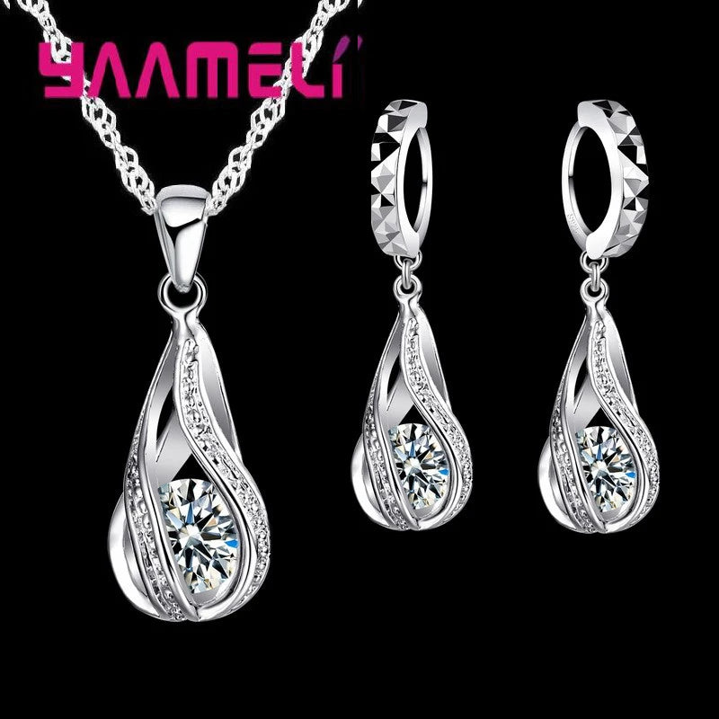 Gold-plated water drop jewelry set with CZ stones by Corporación Turística, featuring a necklace and matching earrings.