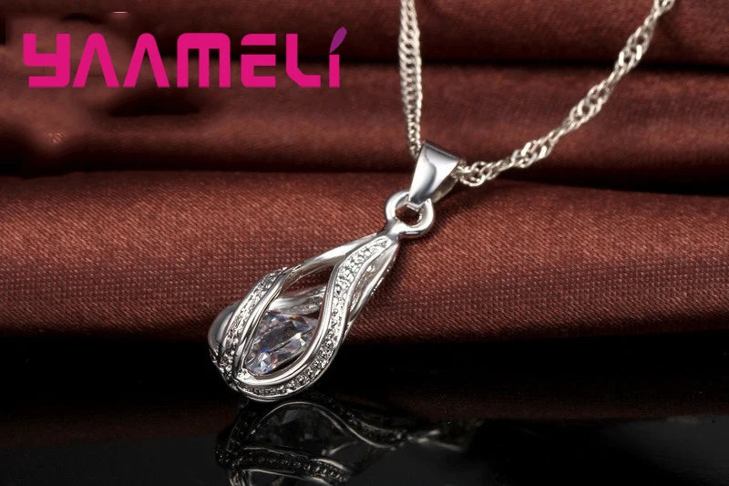 Gold-plated CZ 925 jewelry set with a water drop design, featuring earrings and necklace, by Corporación Turística.