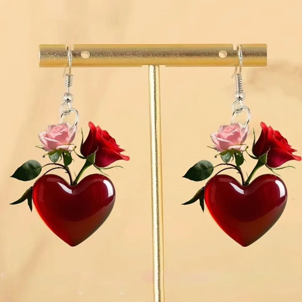 Acrylic heart-shaped dangling earrings from Corporación Turística, featuring bold, colorful pendant design for stylish wear.