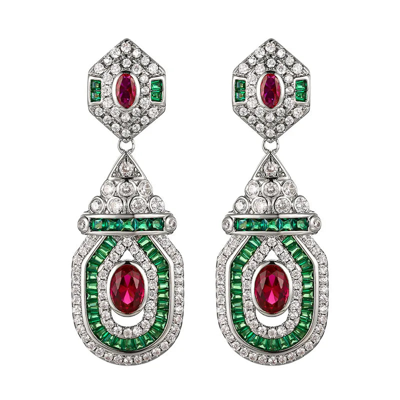 Vintage style dangling earrings from Corporación Turística featuring red stud accents and trendy design.