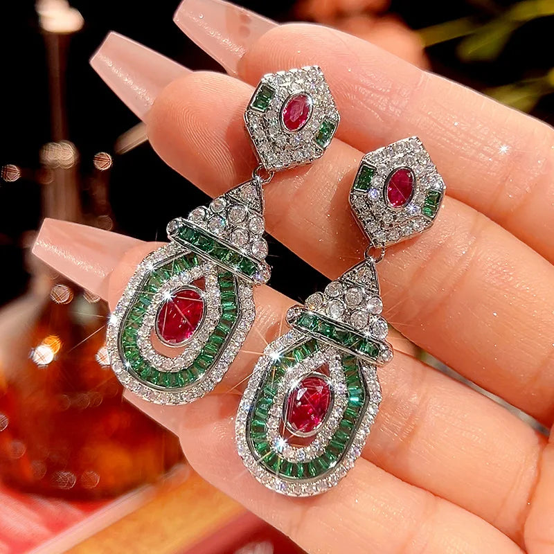 Vintage style dangling earrings by Corporación Turística featuring red stud accents and fashionable design.
