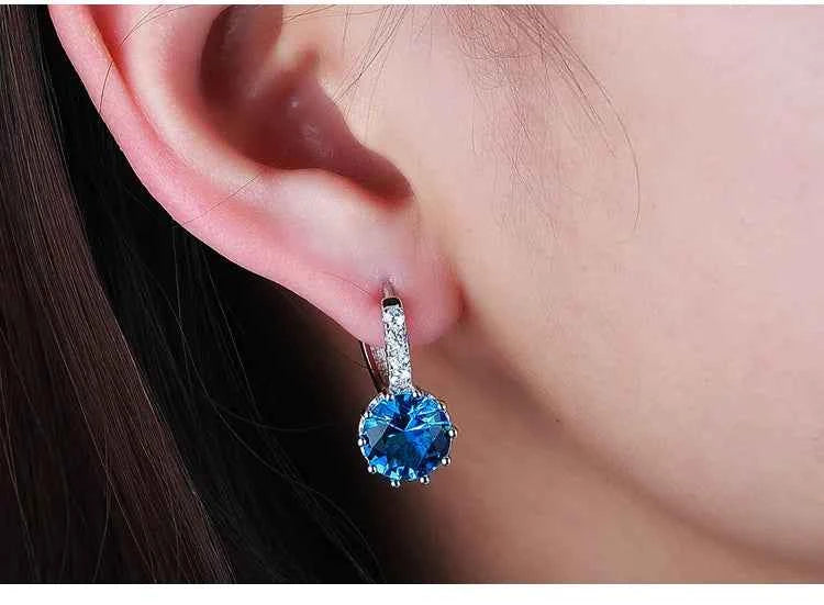 Red circular cubic zirconia hoop earrings for women by YAAMELI, featuring sparkling gemstone accents and a stylish design.