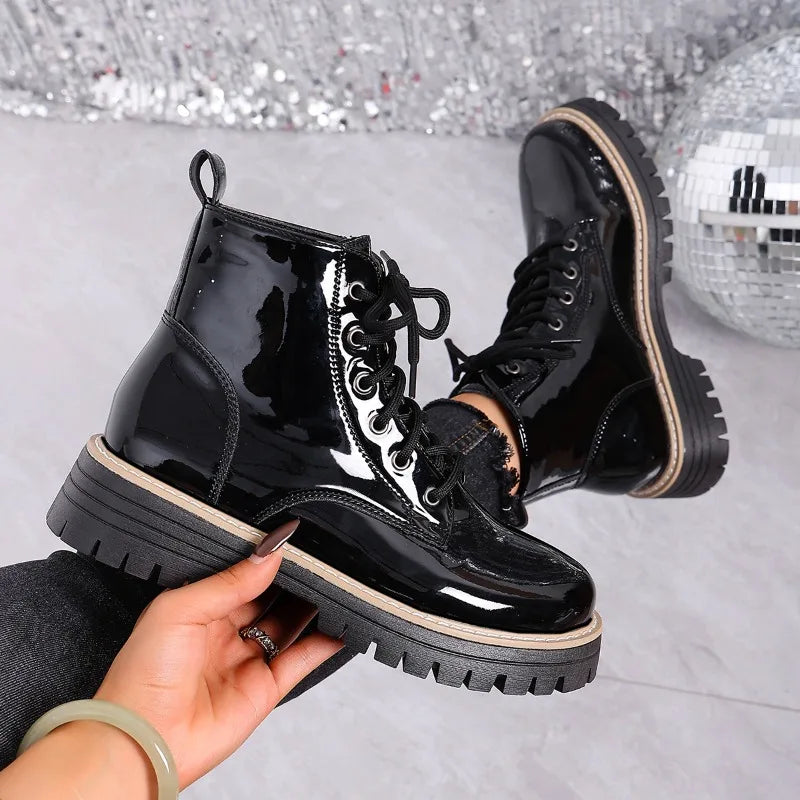 Red patent leather platform combat boots with laces from Corporación Turística, showcasing a stylish and bold design.