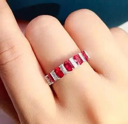 Elegant white cubic zirconia ring for women featuring a luxurious design, showcased on a red background.