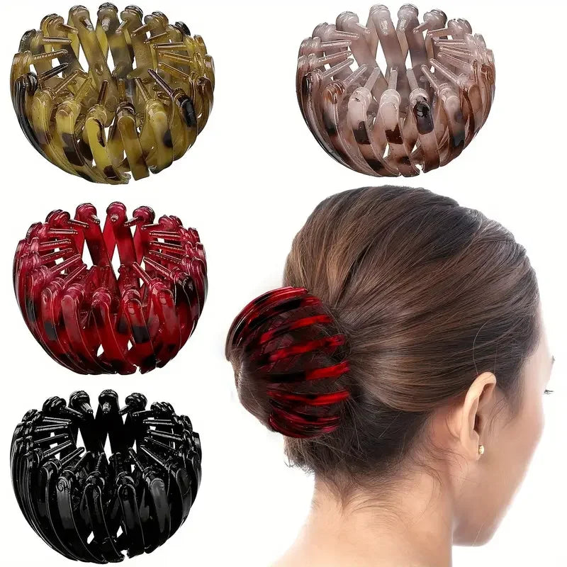 Red bird-shaped hair clip by Corporación Turística, stylish hairpin with a nest design, perfect for securing hair in a fashionable way.