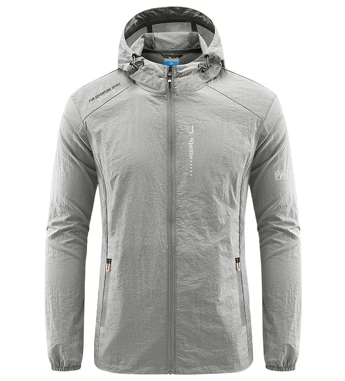 Light grey men's UPF50+ quick-dry sports jacket by Corporación Turística, ideal for hiking and cycling, shown on a model.