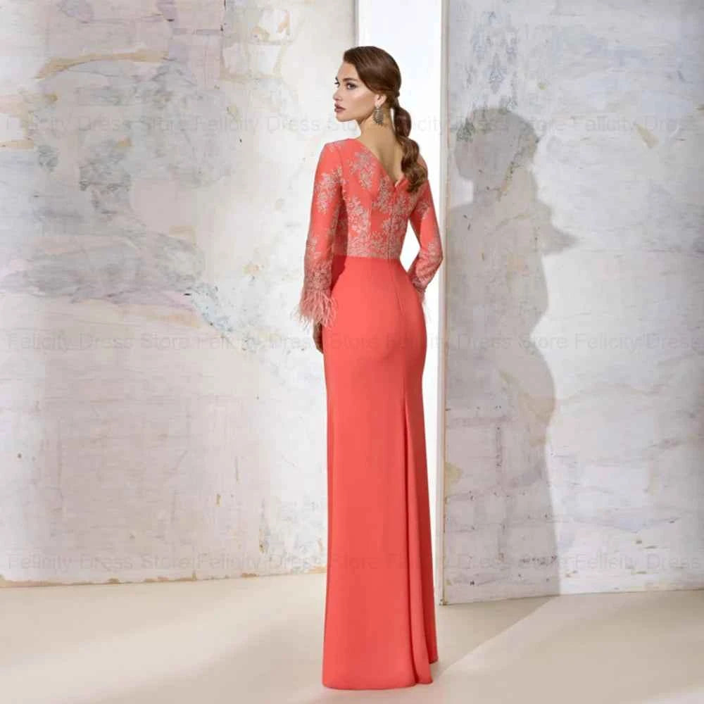 Elegant black mother-of-the-bride evening dress with luxurious feathers, timeless style, from Corporación Turística's 2025 fiesta collection.