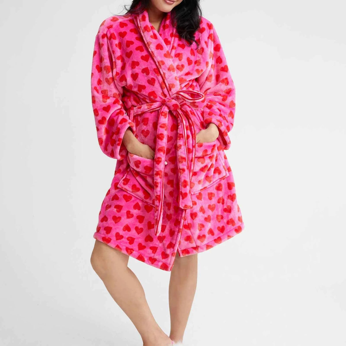 Pink women's warm flannel bathrobe from Corporación Turística, cozy fleece loungewear for relaxing at home.