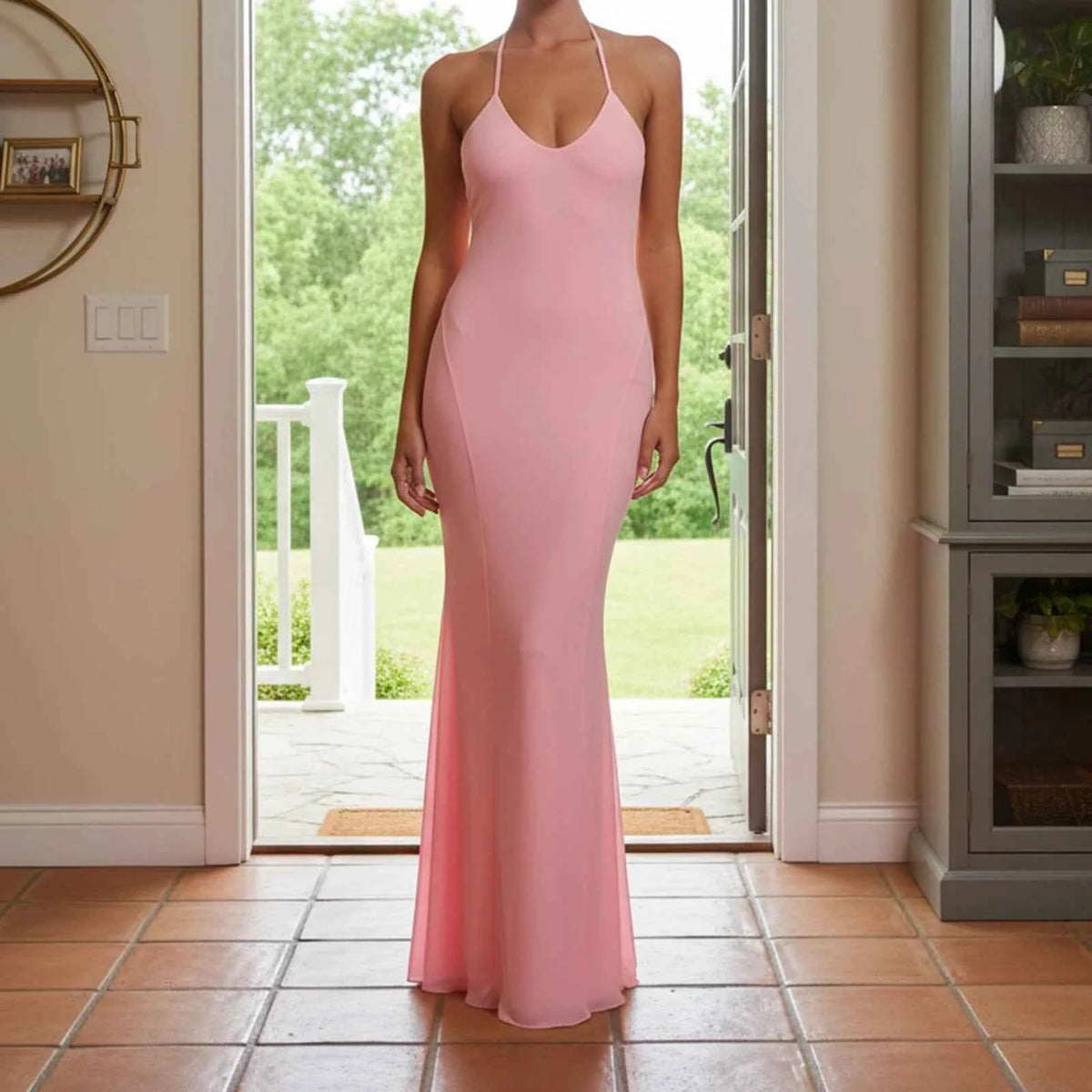 Pink sleeveless maxi evening dress with a halter neckline by Corporación Turística, form-fitting and elegant for special occasions.