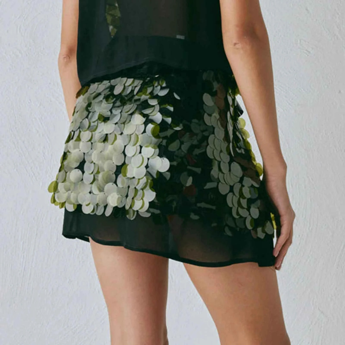 Pink sequin mini skirt for women, summer fashion, by Corporación Turística, with a slim fit and shiny embellishments.