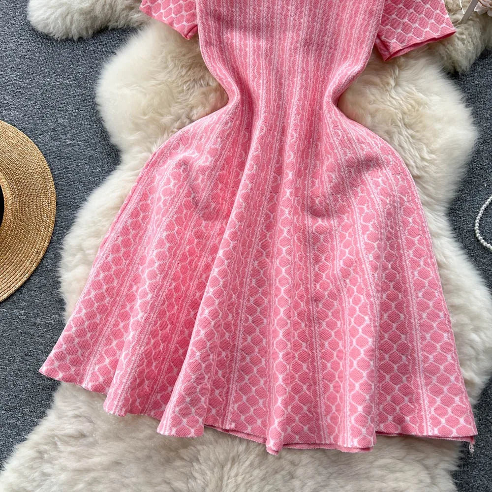 Pink short knit dress with A-line cut by YuooMuoo, featuring a stylish, fitted bodice and flowing skirt, perfect for casual wear.