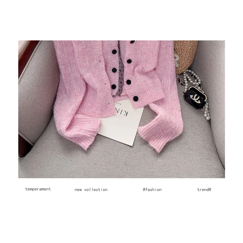 Pink cardigan with buttons and fake two-piece sweater top from Corporación Turística, styled as a cozy layered outfit.