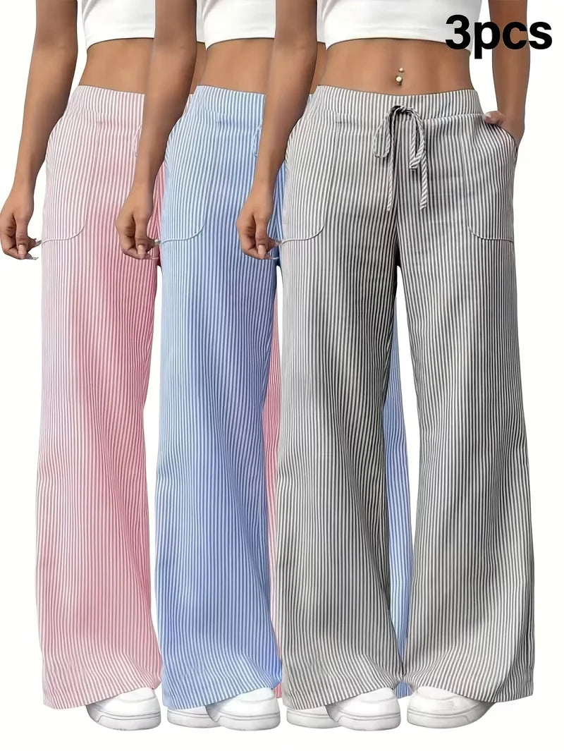 Three-piece women's sports pants set by Corporación Turística, featuring pink athletic pants in XL size, displayed on a neutral background.