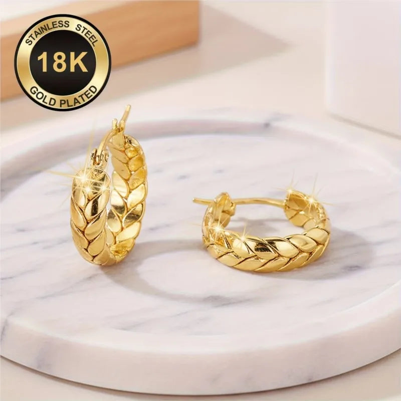 Silver 16mm stainless steel hoop earrings with gold plating by Corporación Turística, showcasing their shiny, smooth finish.