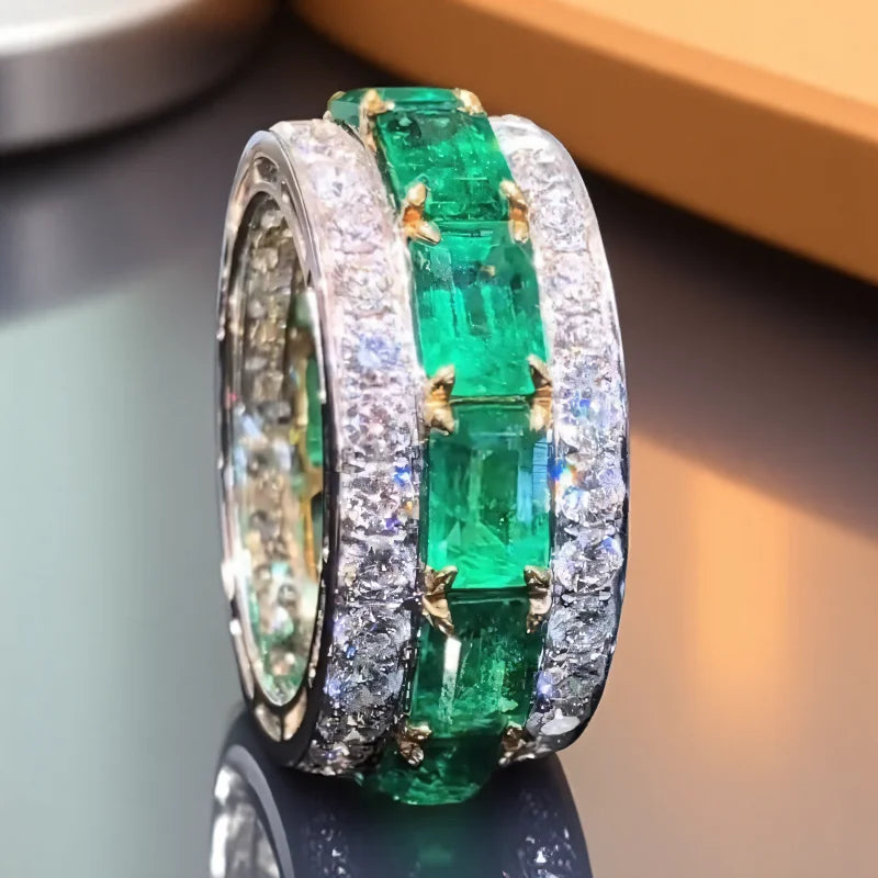 Silver wedding rings with square green stones and full zirconia detail, crafted by Corporación Turística.