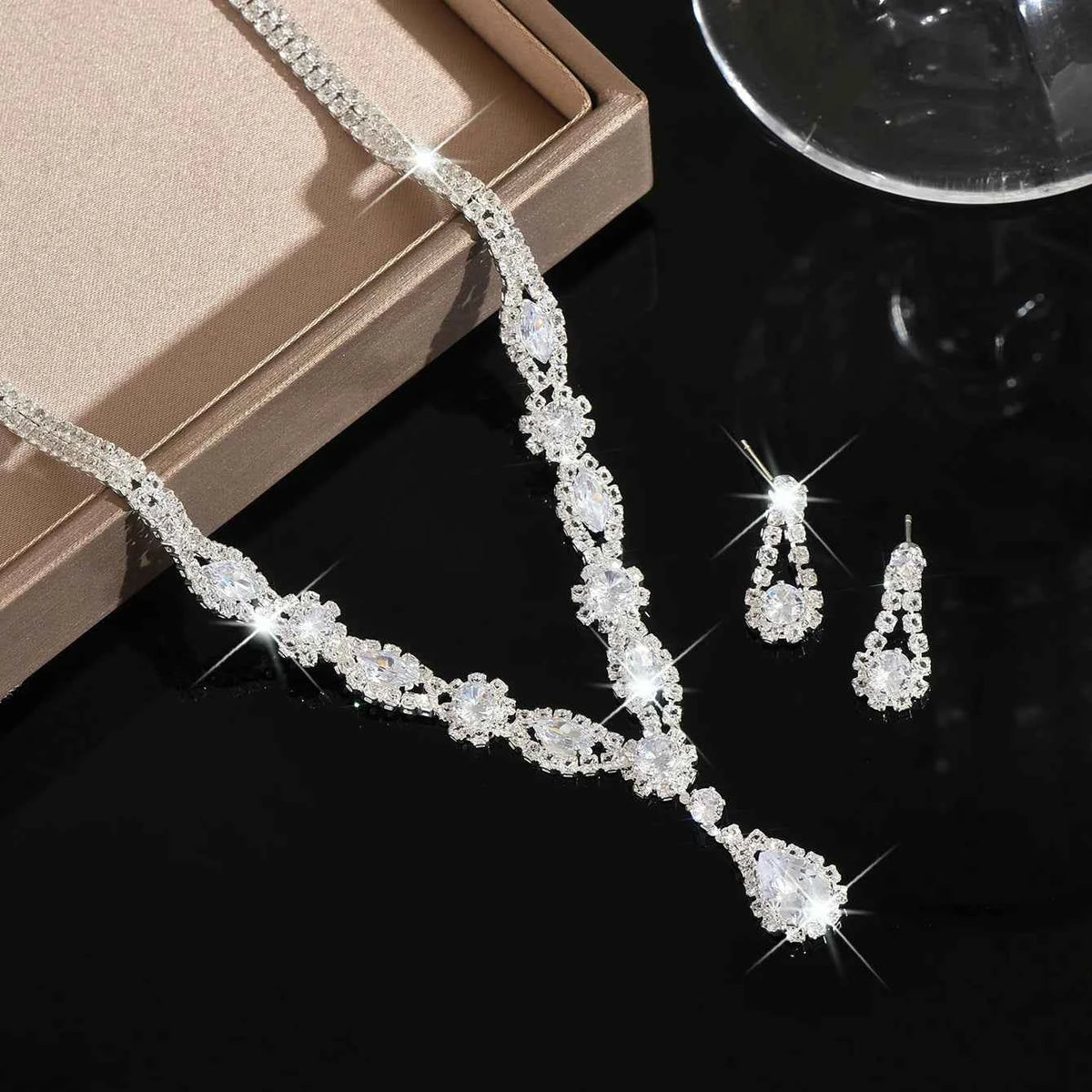 Luxury silver crystal jewelry set featuring elegant shaped pieces, perfect for sophisticated accessorizing.