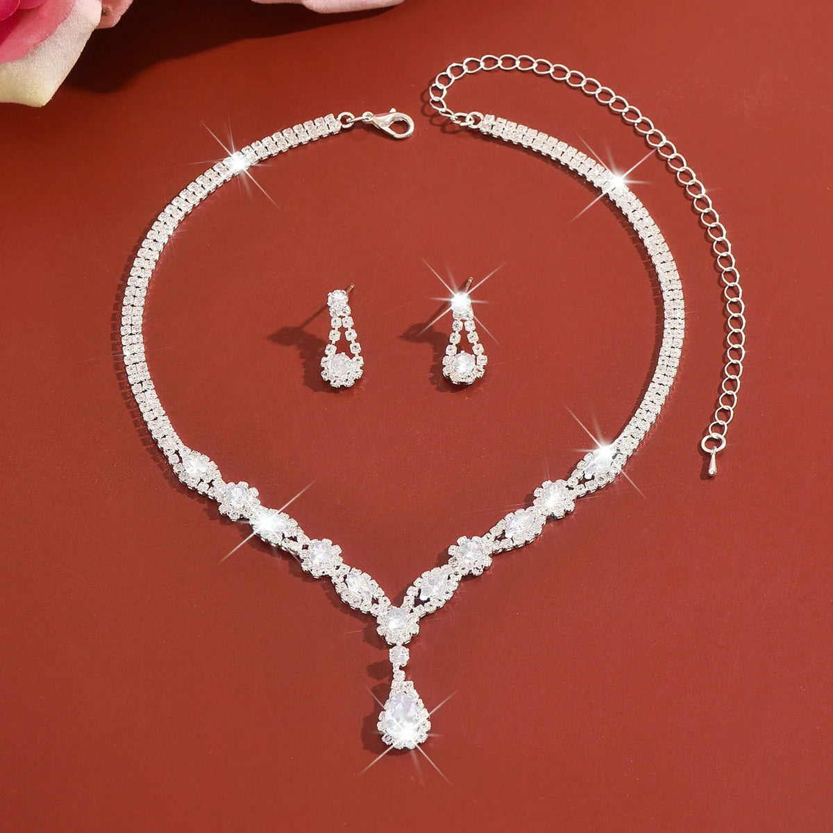 Luxury silver crystal jewelry set featuring elegant design, includes necklace and earrings with intricate crystal details.