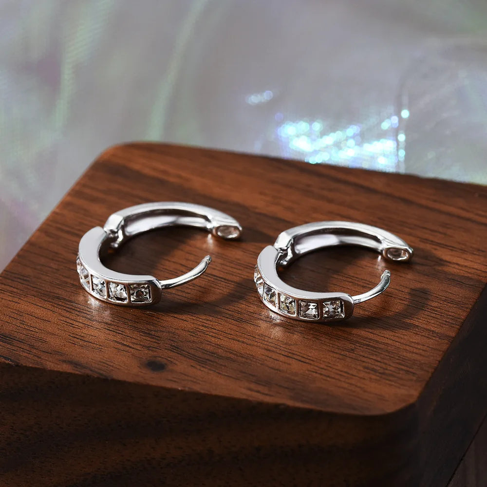 Silver 92% sterling earrings with sparkling cubic zirconia stones, featuring a stylish and elegant design.