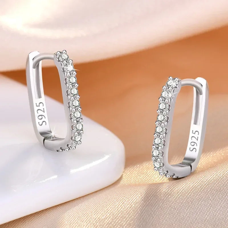 Sterling silver 925 circular hoop earrings with decorative design, stylish jewelry by Corporación Turística.