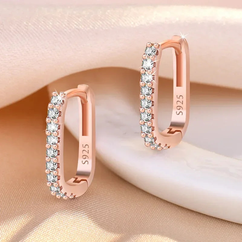 Sterling silver 925 circular hoop earrings, stylish jewelry by Corporación Turística, displayed on a neutral background.