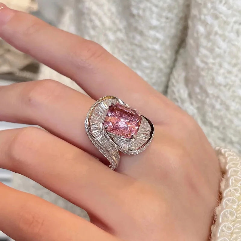 Silver adjustable ring featuring pink quartz dangle charms with floral designs, perfect for wedding jewelry and special occasions.