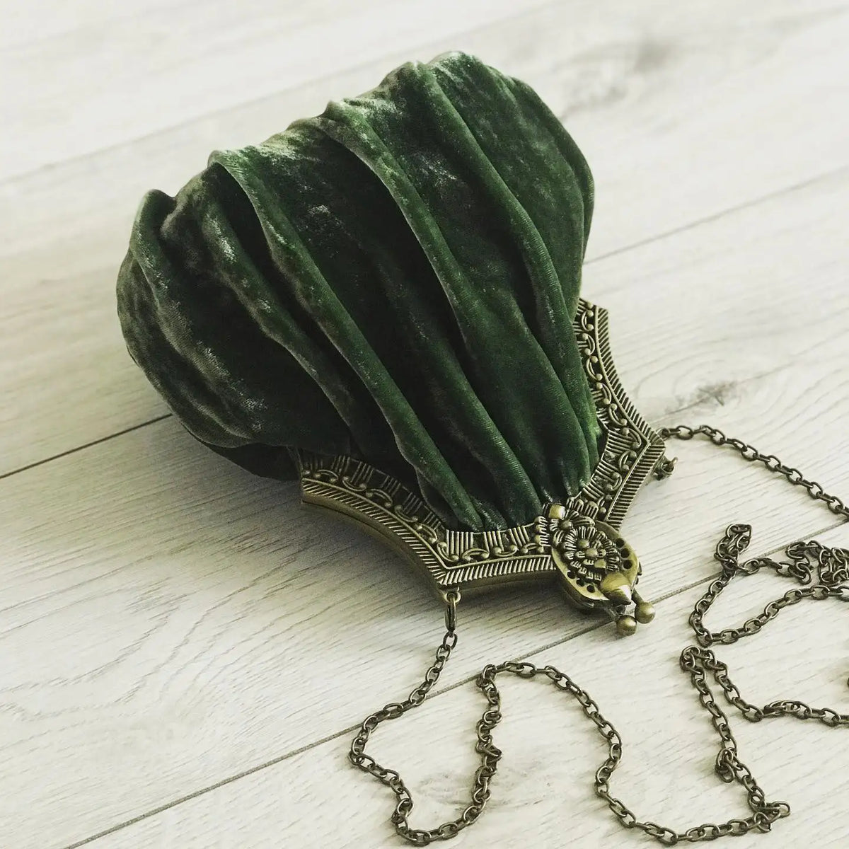 Vintage velvet clutch bag with solid color and clasp closure, stylish hand-held accessory by Corporación Turística.