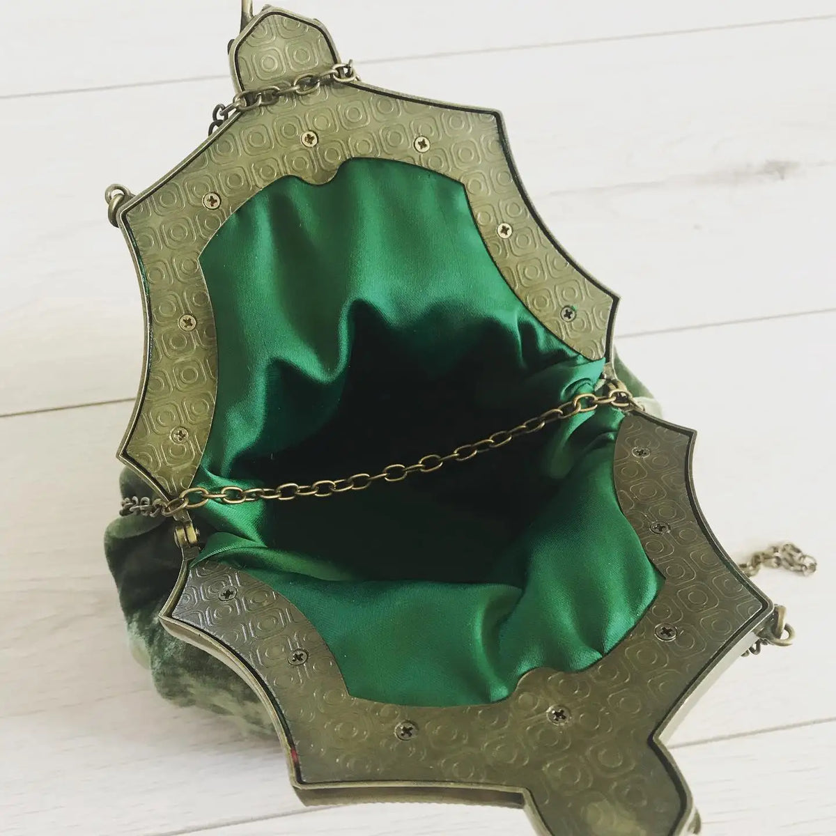 Vintage velvet clutch bag with solid color and metal clasp, stylish hand-held purse by Corporación Turística.