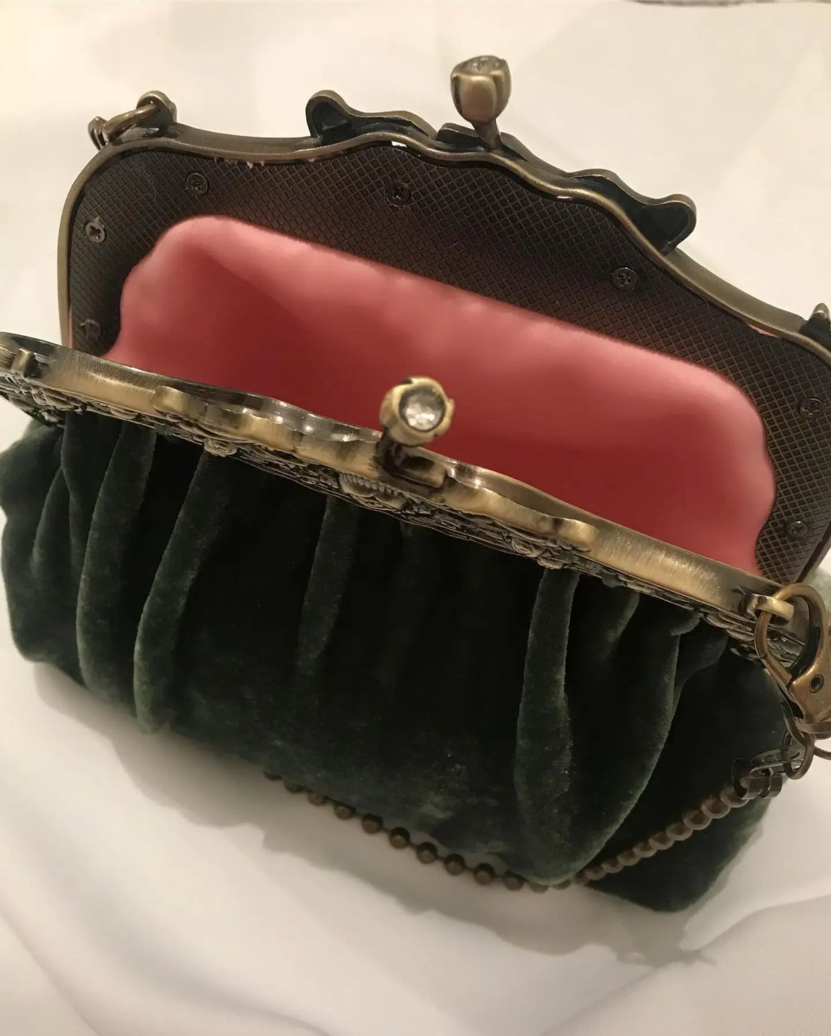 Vintage solid velvet clutch bag with metal clasp from Corporación Turística, featuring a sleek, elegant design and soft texture.