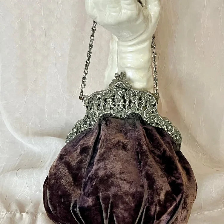 Vintage velvet clutch bag with solid color and metal clasp, stylish hand-held accessory from Corporación Turística.