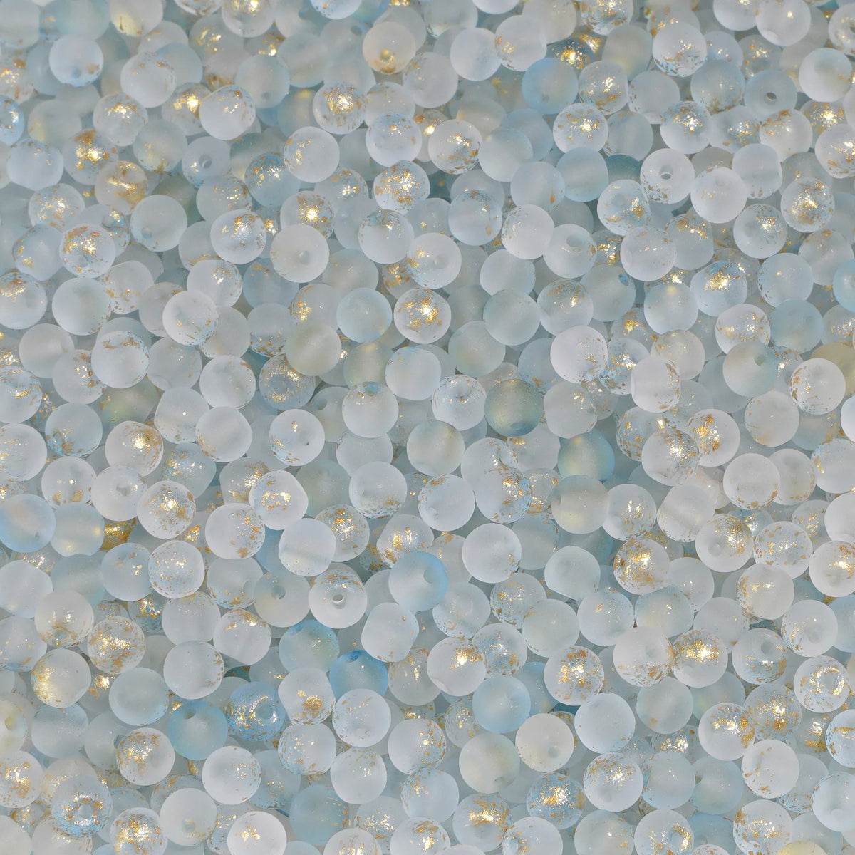 Set of 100 gold-splashed glass rice beads from Corporación Turística, 4mm, ideal for jewelry making and craft projects.