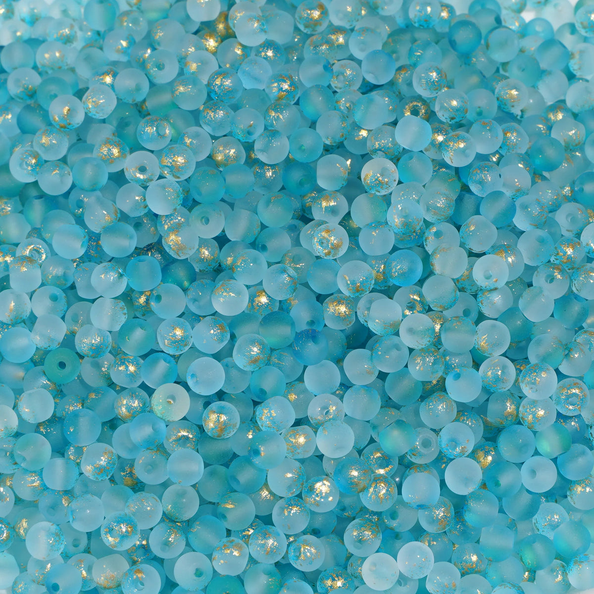 Set of 100 gold-splashed 4mm glass rice beads from Corporación Turística, featuring shiny, decorative jewelry beads.